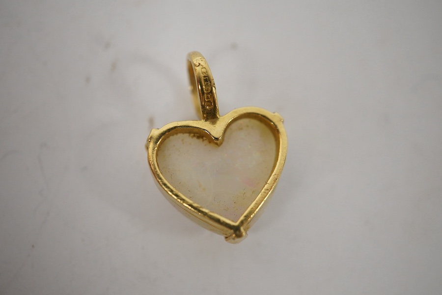 A modern 18ct gold mounted heart shaped white opal pendant, overall 20mm, gross weight 3.2 grams. Condition - fair to good